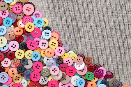 buttons frame with colored buttons on fabric texture backgroundの写真素材
