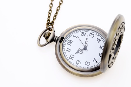 antique pocket watch with chain on white backgroundの写真素材