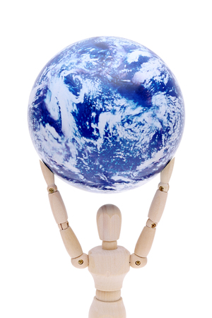 eco concept, wooden model dummy holding globe over head isolated on white backgroundの写真素材