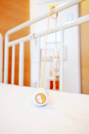 Emergency button for calling nurse equipment on bed