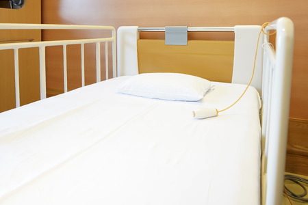 Room with empty bed and medical equipmentの写真素材
