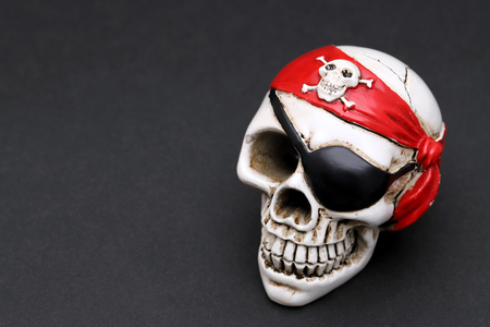 Pirate skull with red head kerchief on dark backgroundの写真素材