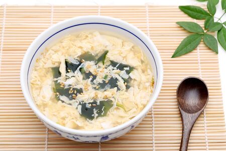 Japanese foof, Kakitama egg soup in a bowl on tableãの写真素材