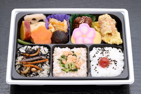 Japanese Makunouchi bento lunch on a black backgroundの写真素材