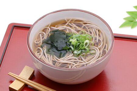 Japanese Kake soba noodles in a ceramic bowl with chopsticks on trayの写真素材