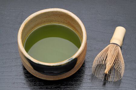 Japanese matcha green tea in a ceramic bowl with tea whiskの写真素材