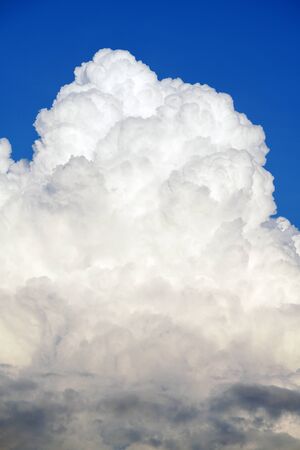 White cumulonimbus clouds in clear blue skyの写真素材