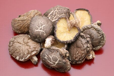 Japanese dried shiitake mushrooms on red backgroundの写真素材