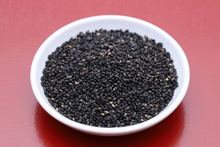 black sesame seeds in a dish on tableの写真素材