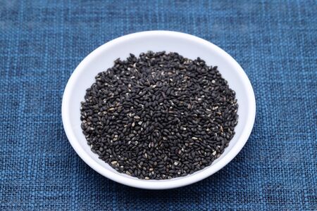 black sesame seeds in a dish on tableの写真素材