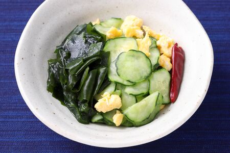 Japanese sunomono food, vinegared cucumber with seaweed wakame in a dishの写真素材