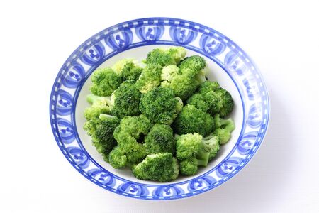 boiled green broccoli with sea salt in a dishの写真素材
