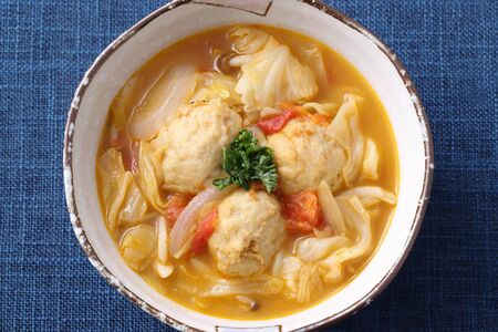 meat ball with vegetable soup in a dish on tableの写真素材
