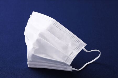 white protection face mask on the tableの写真素材