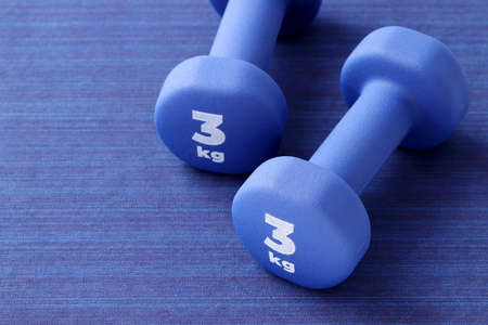 Two pairs of blue fitness dumbbells on floor, Concept healthy lifestyle, sport and diet. Sport equipment.の写真素材
