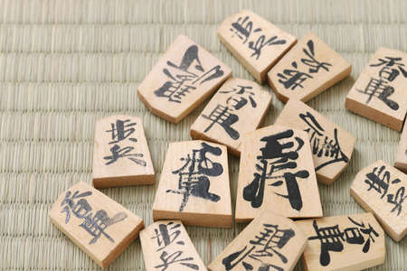 Japanese Shogi pieces on a Tatami background, Shogi is Japanese chess. Word that is written in the piece is king.の写真素材