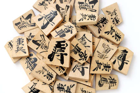 Japanese Shogi pieces on a white background, Shogi is Japanese chess. Word that is written in the piece is king.の写真素材