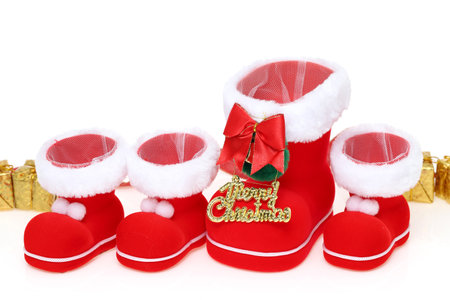 Red Santa's boots with copyspace isolated on white backgroundの写真素材