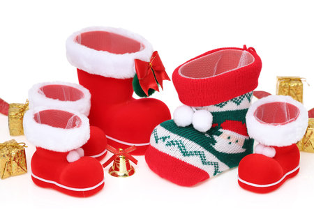 Red Santa's boots with present isolated on white backgroundの写真素材