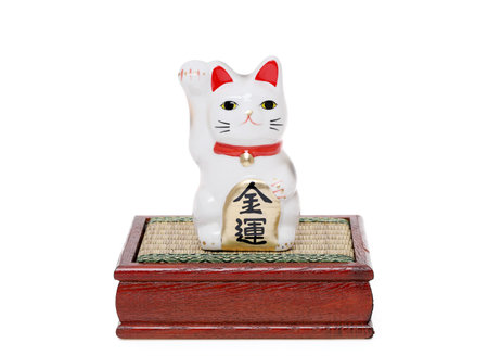 Maneki Neko lucky cat doll, Japanese word of this photography means "economic fortune"の写真素材