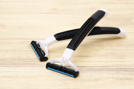 disposable shaving razor on brown wooden tableの写真素材