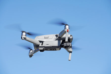 drone flying in air and clear blue sky backgroundの写真素材