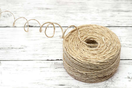 clew of linen twine on white grunge wooden tableの写真素材