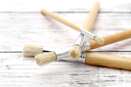 Paintbrushes on white grunge wooden tableの写真素材