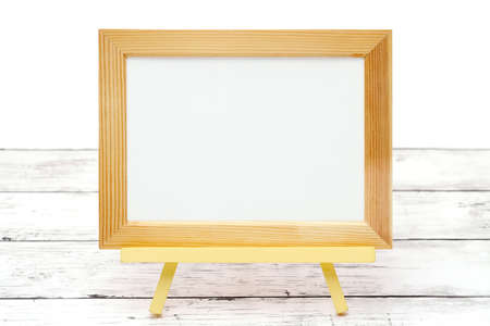 natural wooden picture frame on white wooden tableの写真素材