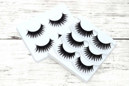 group of false eyelashes on white tableの写真素材