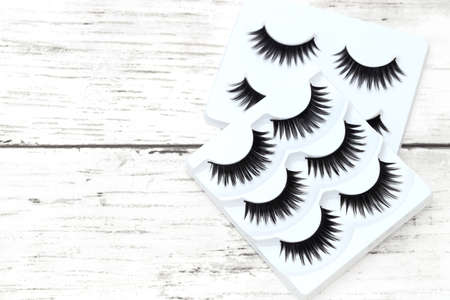 group of false eyelashes on white tableの写真素材