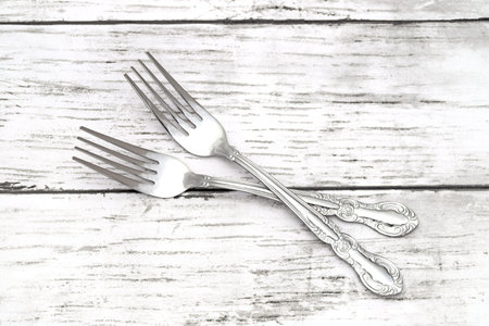 Dining retro forks on white grunge wooden table