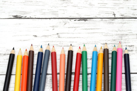 wooden colorful pencils on white wooden table