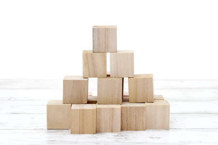 natural wooden toy blocks on white wooden tableの写真素材