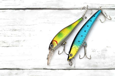 Plastic fishing lure on a white wooden tableの写真素材