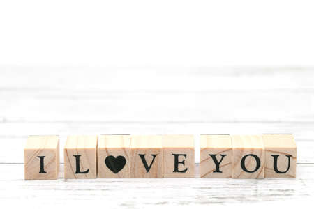 Wood type stamps with the word I LOVE YOU printed on a tableの写真素材