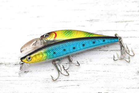 Plastic fishing lure on a white wooden tableの写真素材