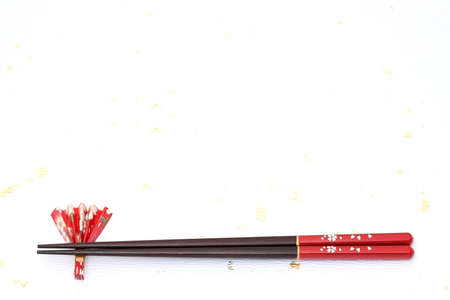 Chopsticks and chopsticks-rest on a white japanese paperの写真素材