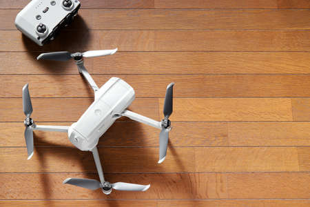 small drone copter with controller on a wooden backgroundの写真素材
