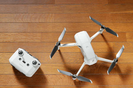 small drone copter with controller on a wooden backgroundの写真素材