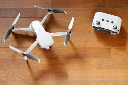 small drone copter with controller on a wooden backgroundの写真素材