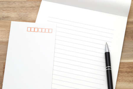 Japanese writing letter paper with ballpoint pen on wooden backgroundの写真素材