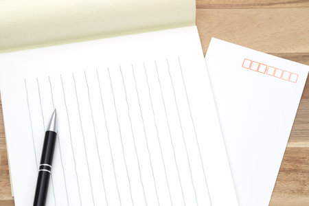 Japanese writing letter paper with ballpoint pen on wooden background