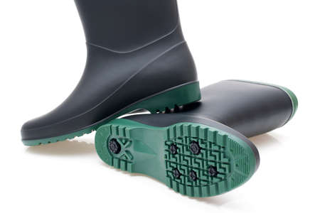 Pair of black waterproof rubber boots isolated on a white backgroundの写真素材
