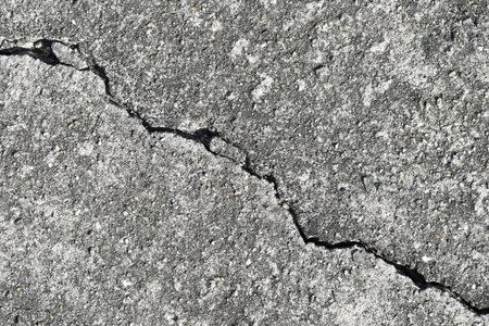 Gray cracked building wall texture for background, copy spaceの写真素材