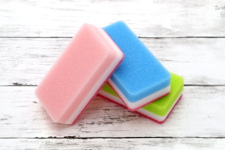 color rectangular sponges for washing dishes and cleaning on white wooden backgroundの写真素材