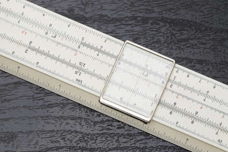 close up of old slide rule on black backgroundの写真素材
