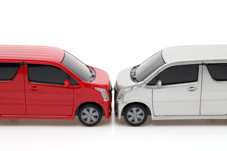 Toy cars crash accident,  Red car and silver car on white backgroundの写真素材