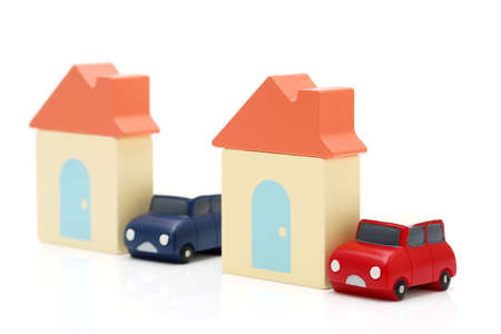 Wooden toy house and toy car isolated on white backgroundの写真素材