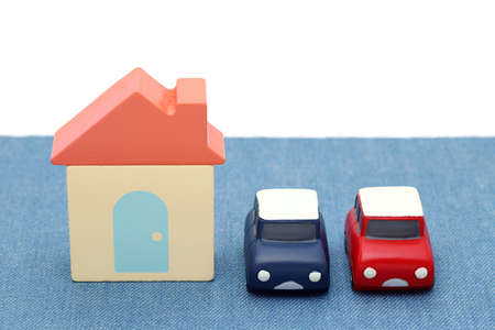 Wooden toy house and toy car isolated on white backgroundの写真素材